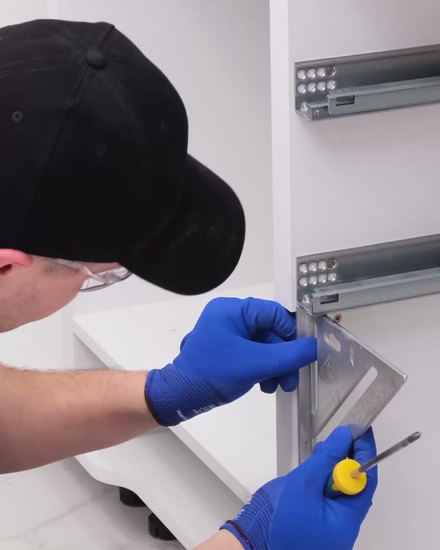 Cabinet hardware being measured and fitted